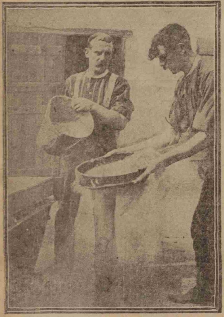 Arthur Bryant (left) and a colleague 'riddling' the maggots to clean them for sale as bait. Leeds Mercury, 31 July 1911 (British Newspaper Archive)