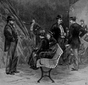 Men and women in 19th-century clothing sit on benches in an underground cave.