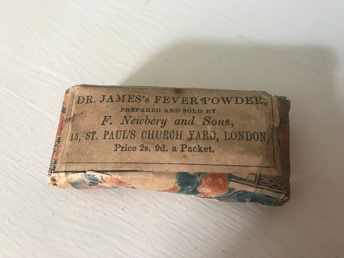 A present-day photograph of a pack of Fever Powder. The object comprises a folded paper with a colourful pattern, and a label saying Dr James's Fever Powder, prepared and sold by F Newbery and Sons, 45 St Paul's Church yard, London. Price 2s. 9d. a packet.